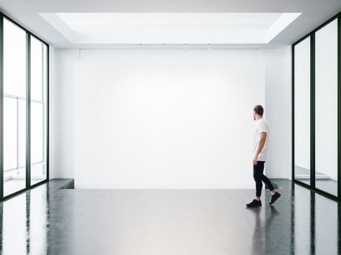 Panoramic windows in the gallery and young man walking
